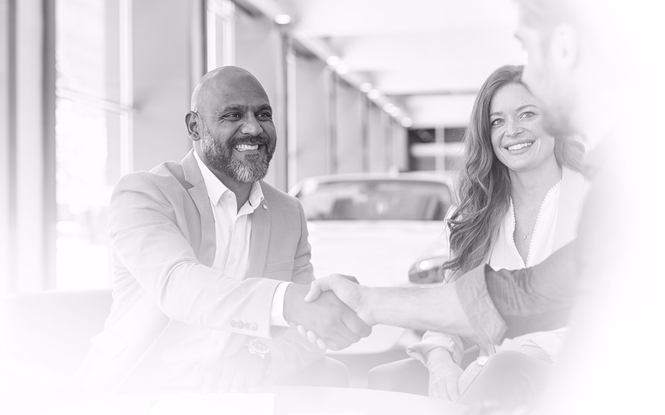 Man And Woman Smiling Shaking Hand With Another Man
