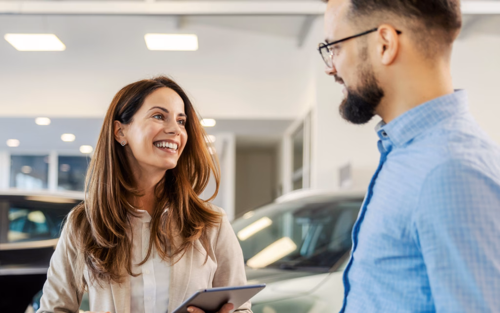 Woman And Man Talkin In Auto Dealership